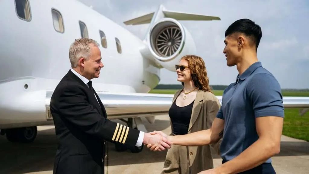 pilot greeting passengers with a handshake